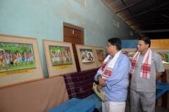 Sri Surjya Hazarika and Sri Sankar Prasad Kakoti Bora viewing painting by artist Manika Das